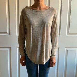 Beige long-sleeved top with high dolphin hem
